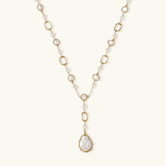 Long gold-plated necklace with alternating freshwater pearls and crystal bezels, featuring a large baroque pearl pendant